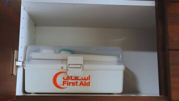 Une trousse de premiers secours blanche, rangée dans un placard.