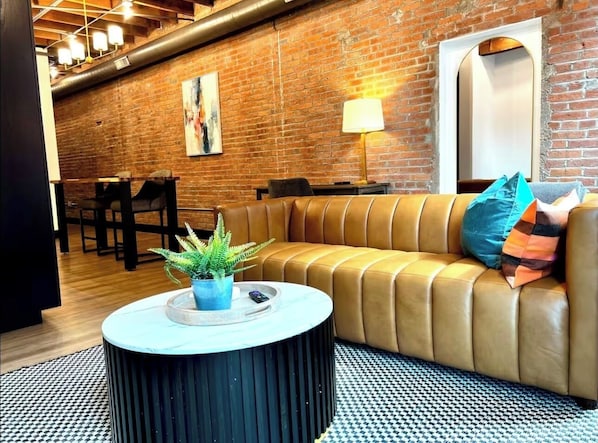 Living area - Brick & Bed - Cheery Riverfront Loft Walk to Arch (St. Louis)