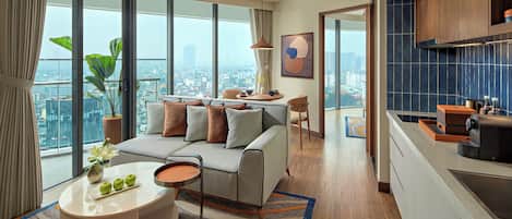 A modern living room with a sofa, coffee table, and city view.