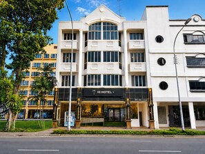 A modern hotel with a prominent entrance, multiple balconies, and a clear view of the street. - Amrise Hotel Geylang (Singapore)