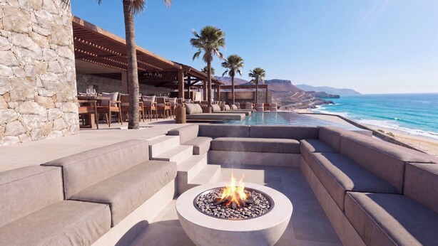 A poolside area with a fire pit, outdoor seating, and a view of the ocean. - Lofos Social House (Hersonissos)