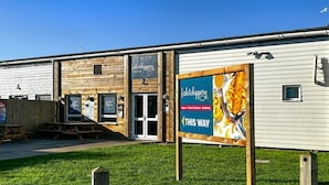 A building with a sign for 'fish&chips' and a delivery service. - MKRJ COMFORT– Parkdean Camber Sands – Sleeps 8 - Pet Friendly - lbl5 (Camber)