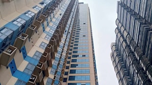 A high-rise building with a modern architectural design, featuring a series of balconies and large windows. - Grand Riviera neas Slec (Manila)