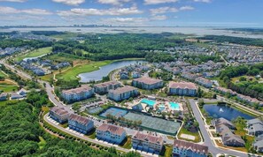 A residential area with houses, a swimming pool, and a tennis court.