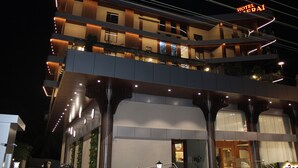 Un hotel de varios pisos con diseño moderno, con balcones, una entrada destacada y un letrero que indica el nombre 'Hotel Merai'.