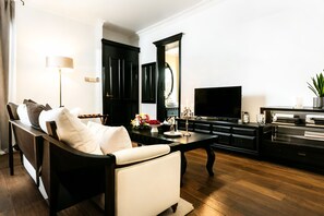 Ein modernes Wohnzimmer mit einer Couch, einem Couchtisch, einem Fernseher und einem Schrank.