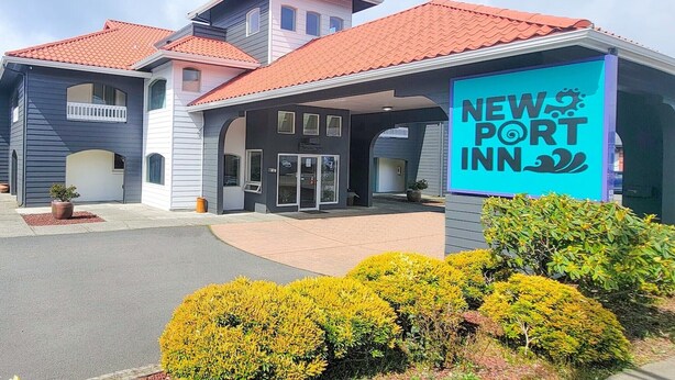 A New Port Inn building with a red-tiled roof, a covered entrance, and a signboard.