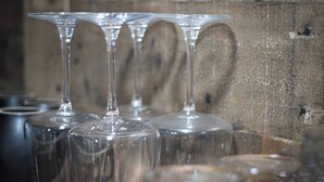 A collection of clear wine glasses with a wooden background.