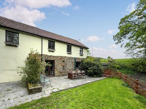A two-story building with a stone facade and a tiled roof. - Brambles Cottage - UK51981 (Little Torrington)