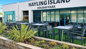 A restaurant named 'Hayling Island Holiday Park' with outdoor seating and a reception area. - 2 bedroom accommodation in Hayling Island (Hayling Island)