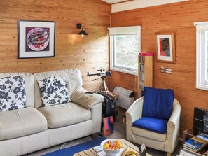 A cozy room with a beige sofa, a blue armchair, a table with fruit, and a telescope. - 3 bedroom accommodation in Cenarth (Cenarth)