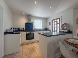 A compact kitchen with a built-in oven, a microwave, and a coffee maker. - 2 bedroom accommodation in Hevingham, near Wroxham (Hevingham, near Wroxham)