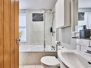 A modern bathroom with a bathtub, toilet, and sink. - No.4 Princess Yellow Apartments - UK52100 (Portrush)