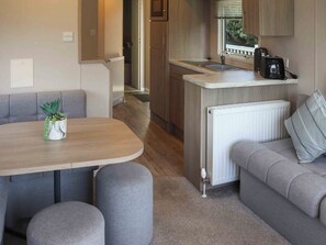 A compact kitchenette with a sink, a coffee maker, and a radiator. - Sarnfaen Static - UK52097 (Tal-y-Bont, near Barmouth)