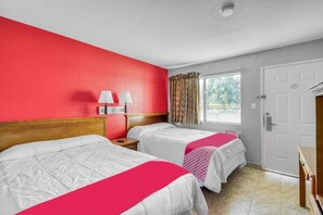 A hotel room with two beds, a window with curtains, a door, and a nightstand with lamps. - Houston | 2 Full Bed (Houston)