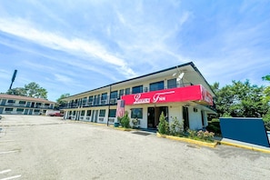 A two-story building with a red awning labeled 'Luxury Inn.'
