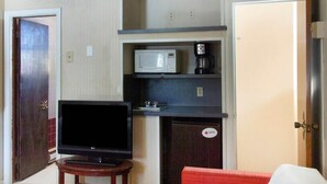 A compact hotel room with a television, a microwave, a coffee maker, and a small cabinet. - 2 Queen Bed|Non-Smoking (Wilkes-Barre PA)