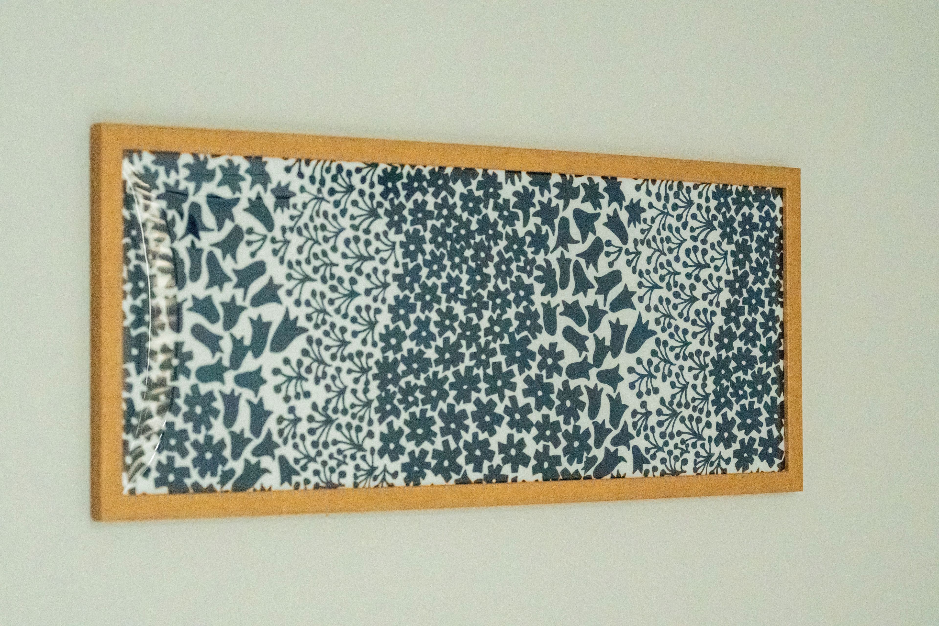 A framed artwork with a complex pattern.