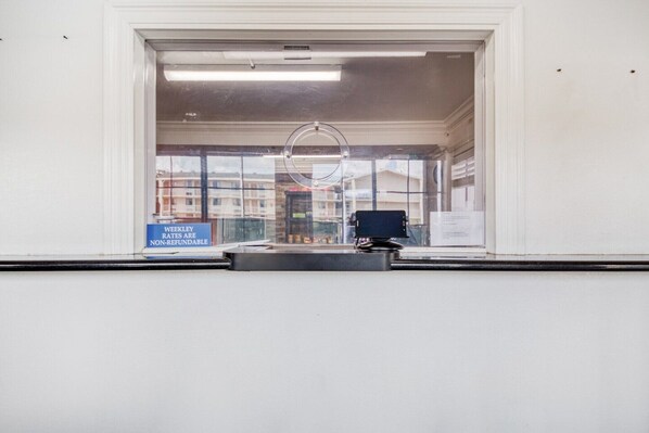 A room with a large window, a desk, and a computer monitor. - Accessible King Bed|Baton Rouge LA (Baton Rouge LA)