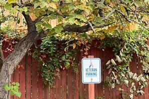A wooden fence with a sign indicating Veteran Parking.