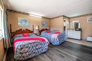 A room with two beds, a desk, a mirror, and a door leading to a bathroom. - 2 Full Bed|Smoking|Calhoun GA (Calhoun GA)