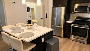 A modern kitchen with a stainless steel refrigerator, oven, and microwave. - Calm & Stylish Hollywood Gateway (Los Angeles)