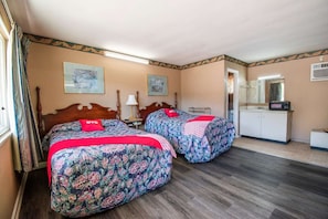 A room with two beds, a dresser, a mirror, and a door leading to a bathroom. - 2 Full Beds|Calhoun GA (Calhoun GA)