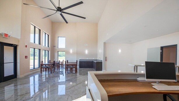 A spacious room with a large desk, a ceiling fan, and a view of the outdoors. - 2 Queen Beds Non-Smoking (Adairsville GA)