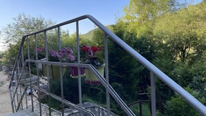 A staircase with metal railings and potted plants.