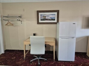 A small room with a desk, chair, and a white refrigerator. - King Bed|Smoking|Chickamauga (Chickamauga)
