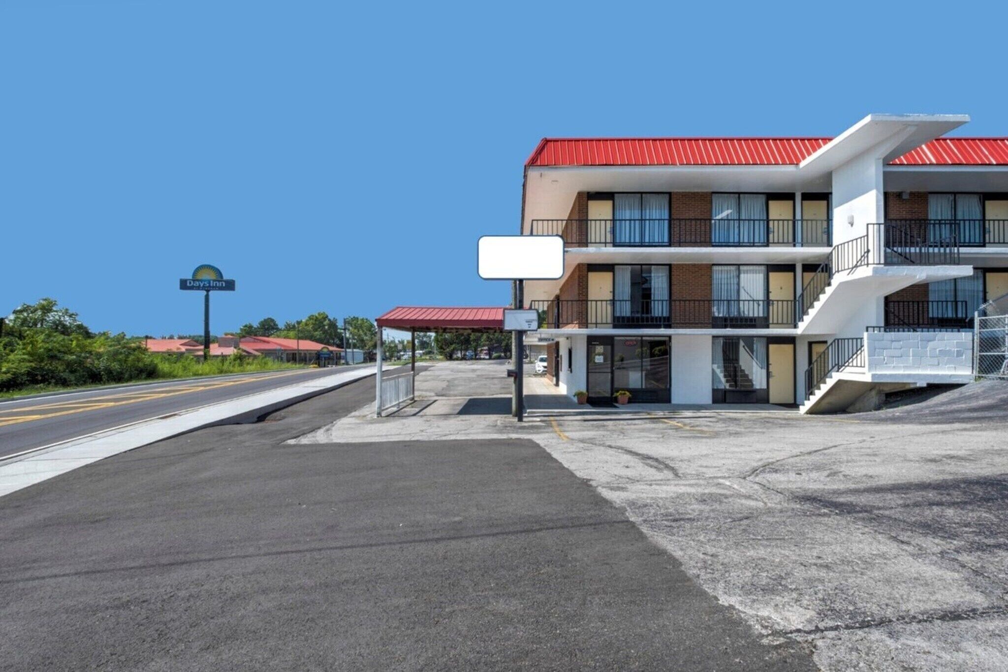A Days Inn with a red roof, a two-story building, and a parking lot.