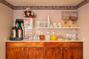 A kitchenette with a coffee maker, tea kettle, sugar and creamer dispensers, and a fruit bowl. - King Bed | Smoking|Texarkana TX (Texarkana TX)