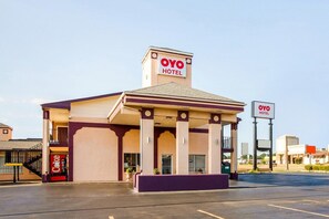 Un hotel con un cartel que dice 'OYO HOTEL' y una máquina expendedora de Coca-Cola.