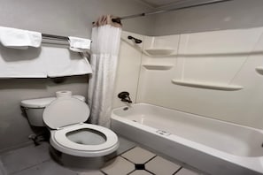 A bathroom with a toilet, a bathtub, a shower curtain, and a towel rack.