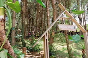 A forested area with a wooden sign reading 'The Nordic Village.'