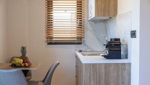 A compact kitchen with a wooden countertop, a built-in microwave, and a small sink.