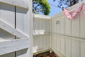 A white wooden outdoor shower area with a hanging hammock. - Walk to Nantucket Sound Beaches! Family Getaway (Dennis Port)
