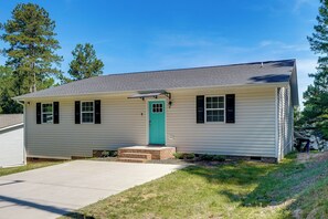 A single-story house with a front door, a small porch, and a clear sky. - NEW Ranch Home By Duke Hospital & UNC Hospitals (Durham)
