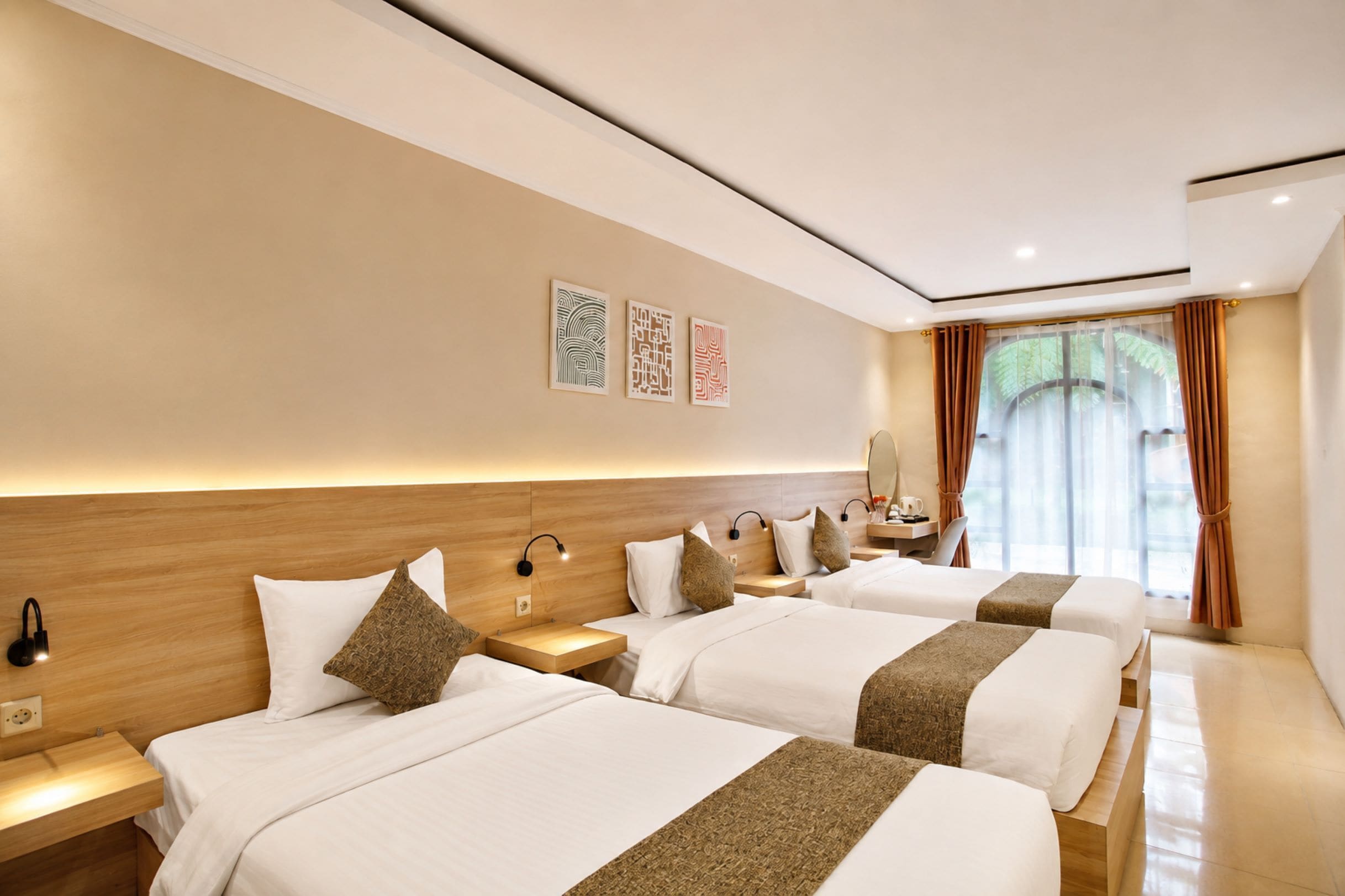 A hotel room with two beds, a nightstand with a lamp, a desk with a chair, and a window with curtains.