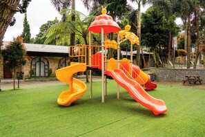 A playground with slides and climbing structures.
