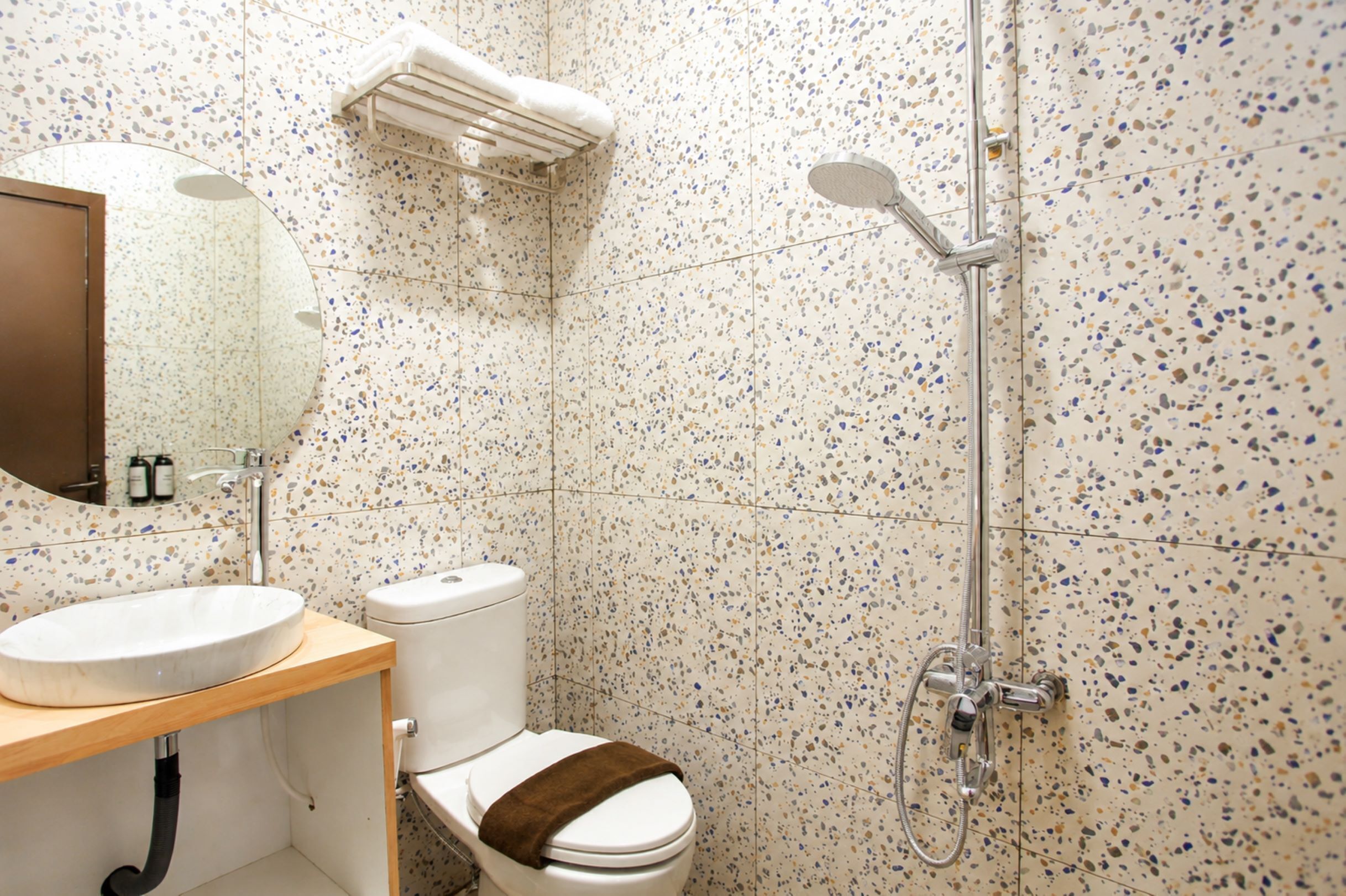 A bathroom with a toilet, sink, and shower.