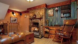 A cozy room with a fireplace, wooden furniture, and a bookshelf. - 2 bedroom accommodation in Broadstairs (Broadstairs)