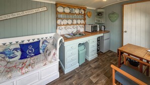 A compact kitchen with a wooden countertop, a microwave, and a sink. - Ewe - Nice - UK51949 (Sutton on Sea, near Mablethorpe)
