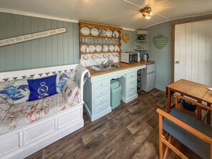 A compact kitchen with a wooden countertop, a microwave, and a sink. - Ewe - Nice - UK51949 (Sutton on Sea, near Mablethorpe)