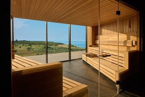 A modern interior with wooden furniture, large windows, and a view of the sea. - Deluxe Studio in Crveni Vrh (Crveni Vrh)