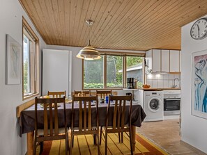 A modern kitchen with a dining area, wooden ceiling, and large windows. - "Haley" - 380m from the sea by Interhome (Hadsund)