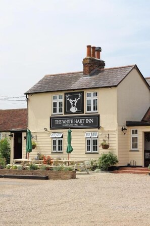 A building with a sign reading 'The White Hart Inn Margaret Tye.' - The White Hart Inn  (Ingatestone)