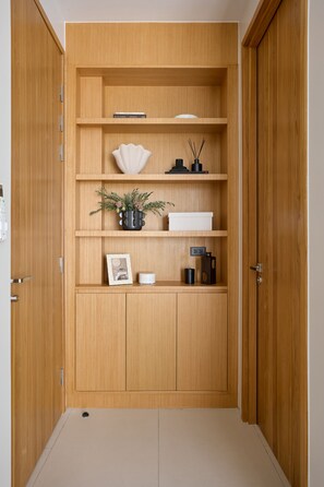 A wooden wardrobe with multiple shelves, a door, and a floor. - Botanica Four Seasons Villas Tropiclook (Thep Krasattri)