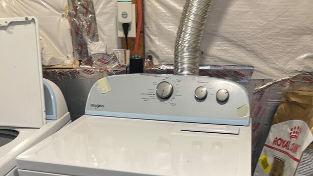 A front-loading Whirlpool washer in a laundry room with tiled flooring and a vent above. - Charming barn in Annapolis for a relaxing getaway not a room just a mattress (Annapolis)