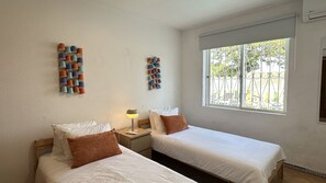 A hotel room with two beds, a window with a view of the outside, and wall-mounted cup holders. - Branca | Private Pool | 12 Pax | Albufeira (Albufeira)